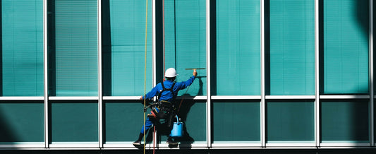 Window washer on the outside of a building cleaning windows.