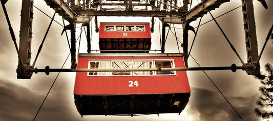 Looking up at two capsules of a ferris wheel.