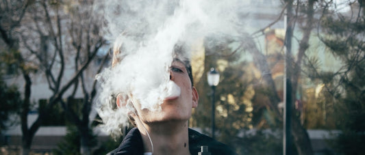 Person vaping hash outside using a vaporizer.